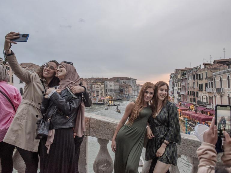 Visitors to Venice, Italy, which attracts millions of tourists each year, May 4, 2022. Starting on April 25, 2024, tourists intending to visit the city on busy dates will be required to register on a website, and those coming for a single day will have to pay a little over $5. 