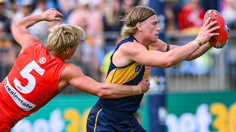 Harley Reid of the West Coast Eagles is tackled by Isaac Heaney of Sydney during the AFL Round 4 match between the West Coast Eagles and the Sydney Swans at the Summit Sport and Recreation Park in Adelaide, Saturday, April 6, 2024. (AAP Image/Michael Errey) NO ARCHIVING, EDITORIAL USE ONLY