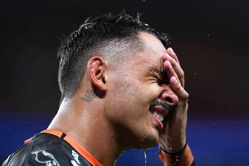 BRISBANE, AUSTRALIA - APRIL 06: Jayden Sullivan of the Wests Tigers wipes his face during the round five NRL match between Dolphins and Wests Tigers at Suncorp Stadium, on April 06, 2024, in Brisbane, Australia. (Photo by Bradley Kanaris/Getty Images)