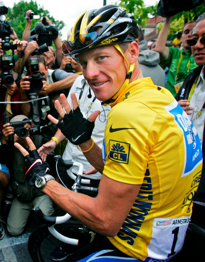 Lance Armstrong gestures for his seventh straight win in the Tour de France.