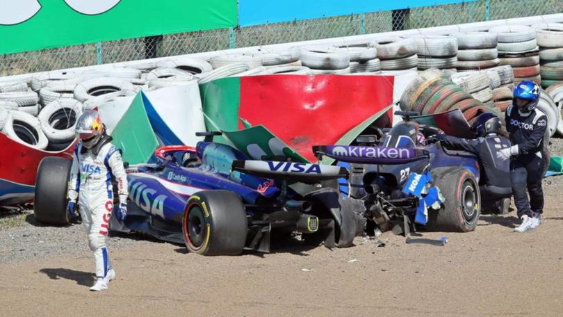 Daniel Ricciardo walks from his first-lap crash in Suzuka with the Williams of Alexander Albon. (EPA PHOTO)