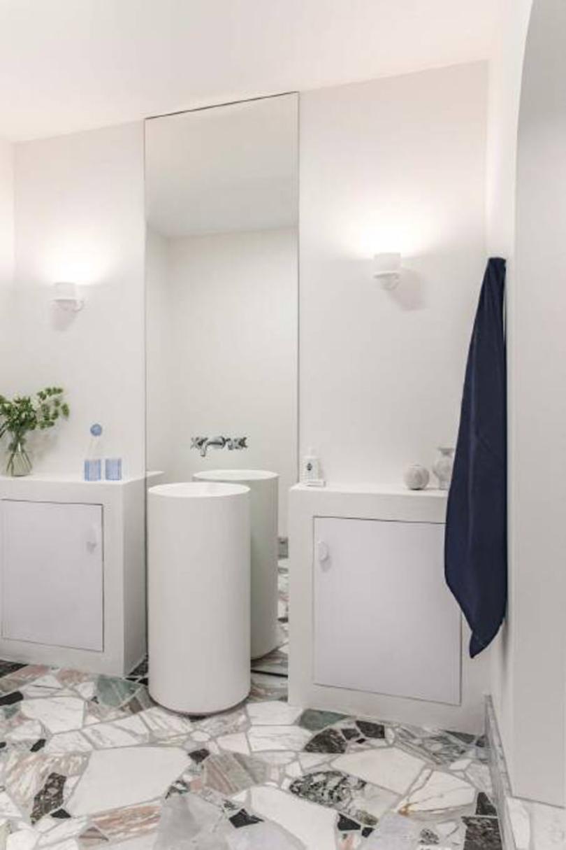 The renovated bathroom has terrazzo tiling.