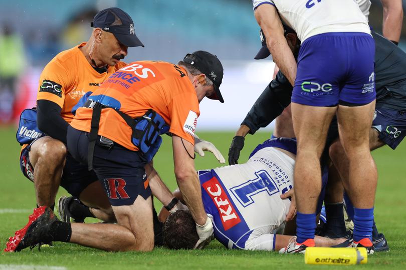 SYDNEY, AUSTRALIA - APRIL 05:  Blake Taaffe of the Bulldogs is attended to by trainers after a high tackle by Dominic Young of the Roosters during the round five NRL match between Canterbury Bulldogs and Sydney Roosters at Accor Stadium on April 05, 2024, in Sydney, Australia. (Photo by Cameron Spencer/Getty Images)