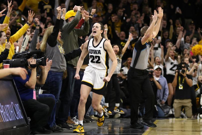 Caitlin Clark celebrates after breaking the NCAA women's all-time scoring record in February.
