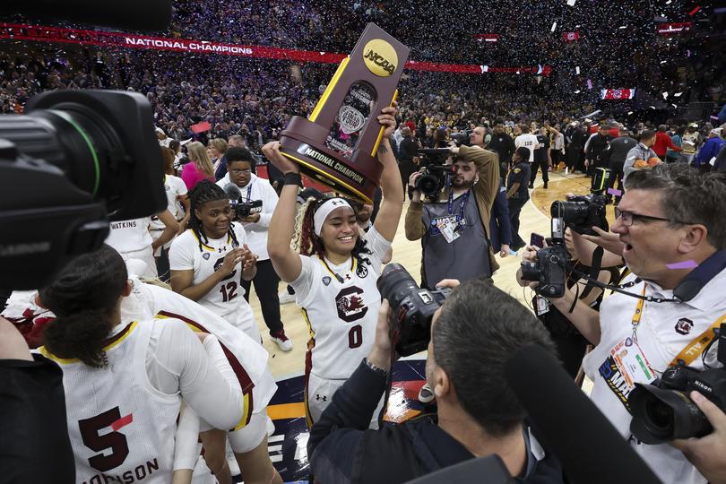  Te-Hina Paopao of the South Carolina Gamecocks hoists the national championship trophy after defeating the Iowa Hawkeyes during the NCAA Women's Basketball Tournament National Championship.