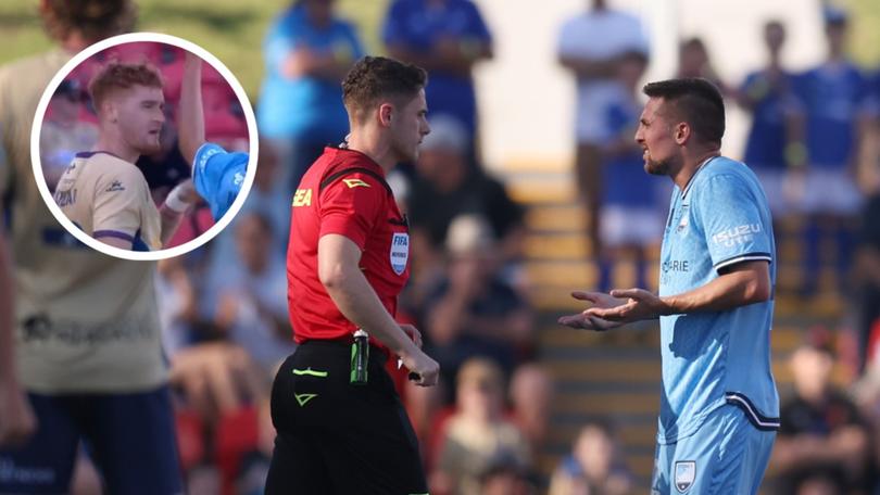 Referee Jack Morgan gives Robert Mak of Sydney FC a red card.