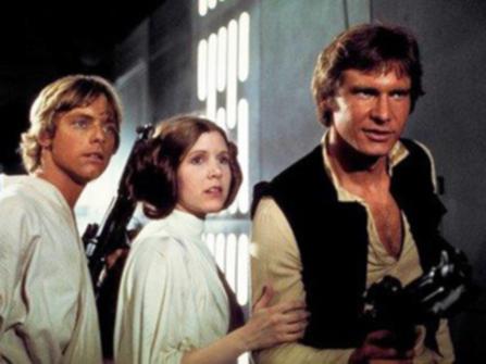 This photo provided by Twentieth Century Fox Home Entertainment shows, Mark Hamill, from left, as Luke Skywalker, Carrie Fisher as Princess Leia Organa, and Harrison Ford as Hans Solo in the original 1977 "Star Wars: Episode IV - A New Hope." The  four-day Star Wars Celebration kicked off Thursday, April 14, 2017 in Orlando, Fla., marking the 40-year anniversary of Lucasâ?? space saga. (Twentieth Century Fox Home Entertainment via AP)