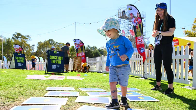 ADELAIDE, AUSTRALIA - APRIL 05: A young fan participates in an activation during the Gather Round Footy Festival at Elder Park on April 05, 2024 in Adelaide, Australia. (Photo by Morgan Hancock/AFL Photos)