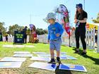 ADELAIDE, AUSTRALIA - APRIL 05: A young fan participates in an activation during the Gather Round Footy Festival at Elder Park on April 05, 2024 in Adelaide, Australia. (Photo by Morgan Hancock/AFL Photos)