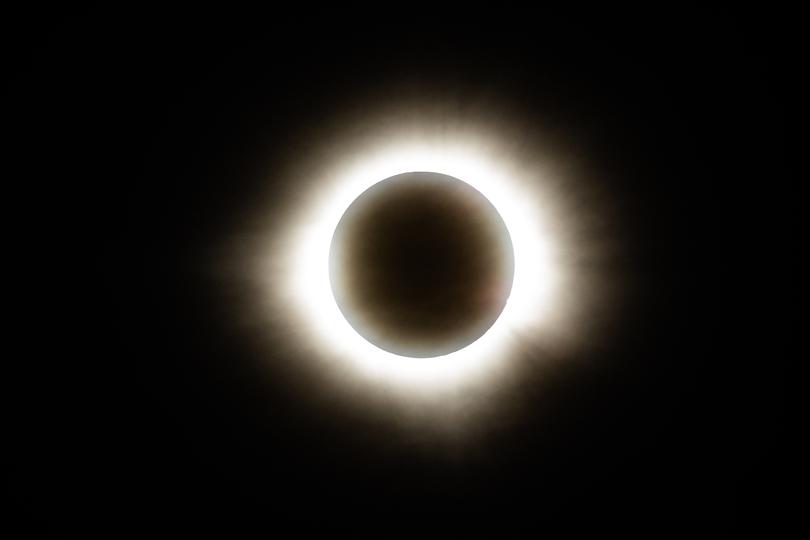The sun disappears behind the moon.