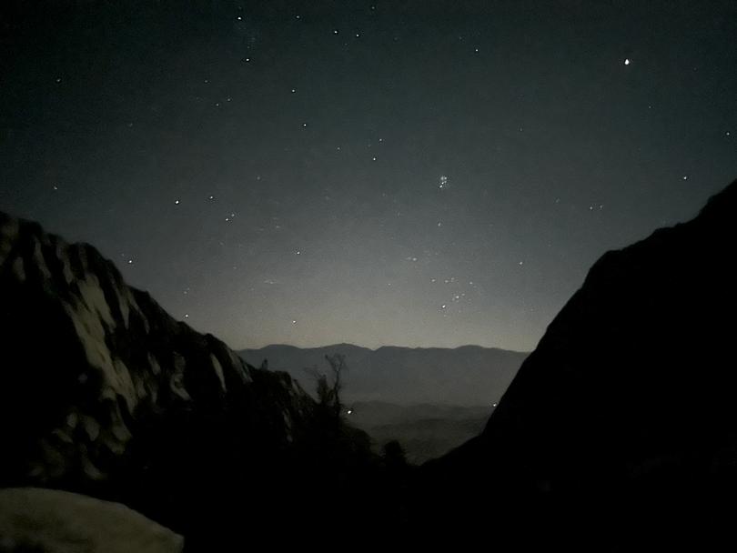 The mountains and the starry sky seen during a hike on Mount Whitney, Calif., in July 2023. Online sources advised starting early in order to reach the summit, a nearly 11-mile hike, before midday.