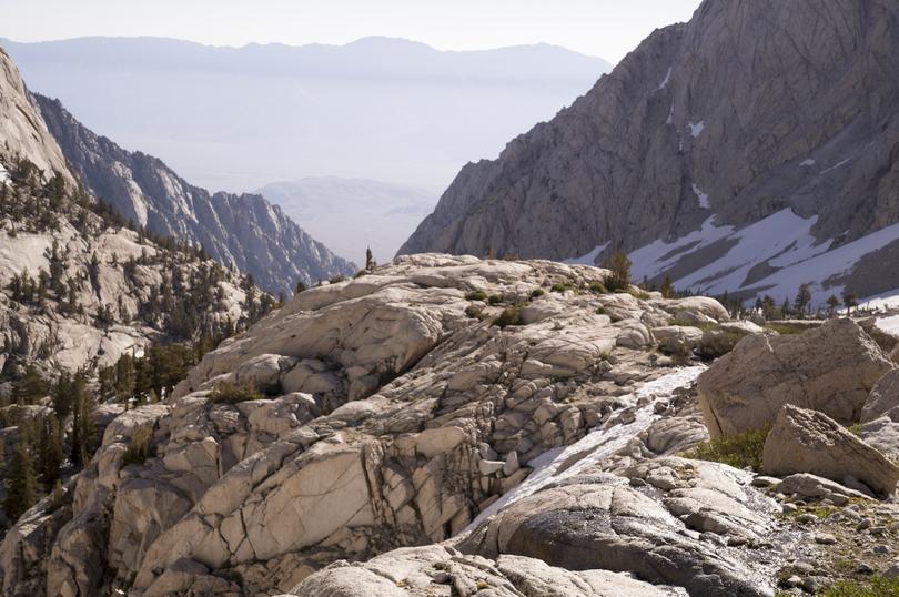 The landscape seen during a hike on Mount Whitney, Calif., in July 2023. At the top of a staircase cut into the rock, the trees disappeared as the trail rose above timberline.