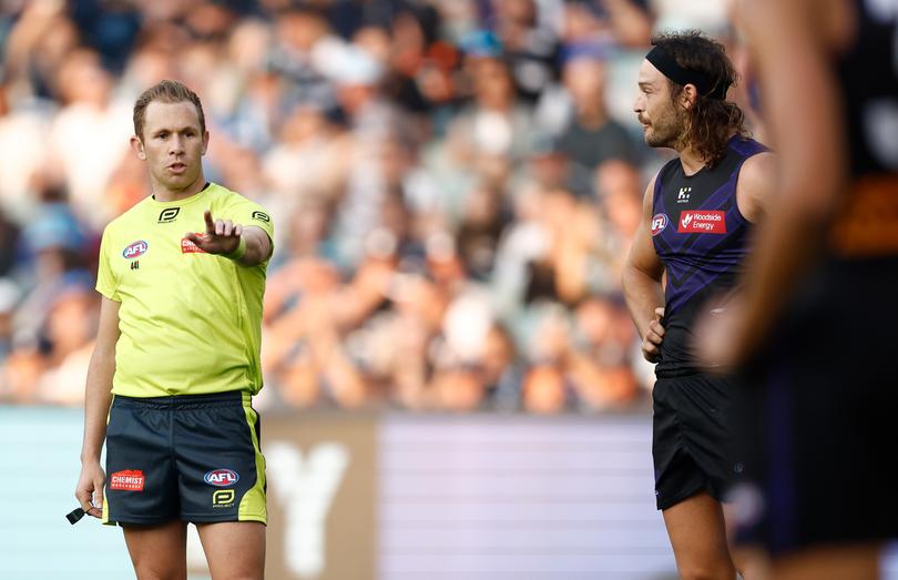 James Aish of the Dockers speaks with the umpire.