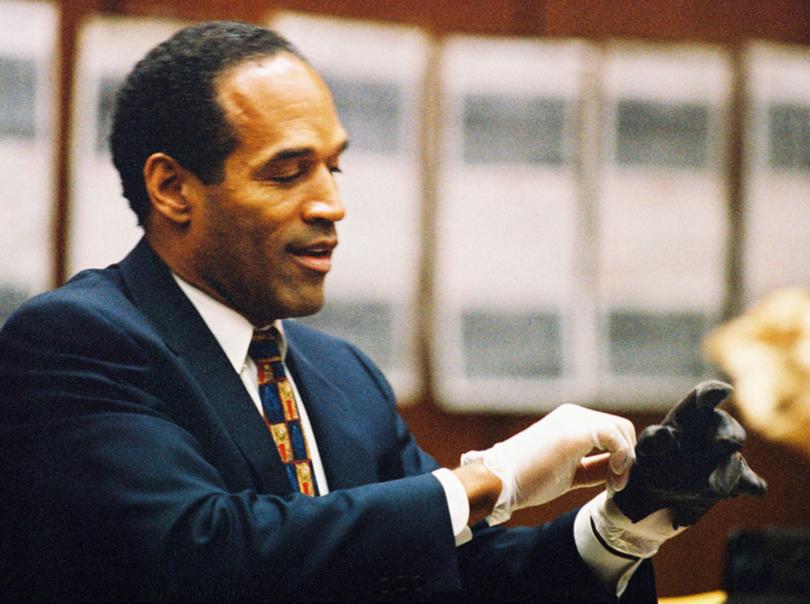O.J. Simpson tries on a leather glove allegedly used in the murders of Nicole Brown Simpson and Ronald Goldman.