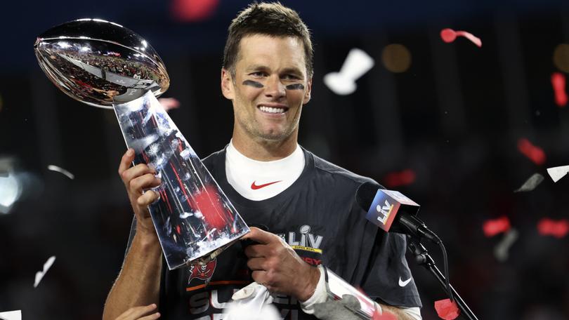 Tom Brady holds the Vince Lombardi trophy following Tampa Bay’s 2021 NFL Super Bowl win.