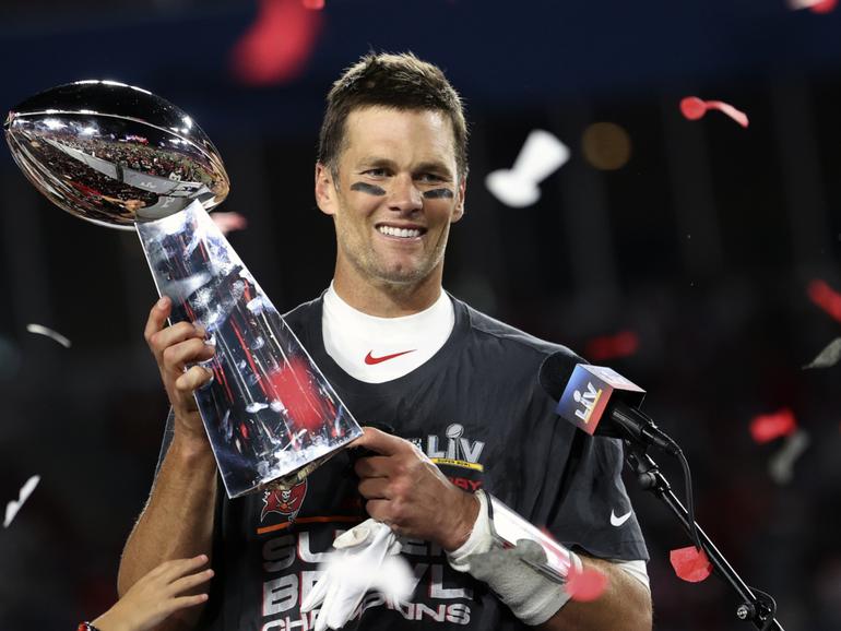 Tom Brady holds the Vince Lombardi trophy following Tampa Bay’s 2021 NFL Super Bowl win.