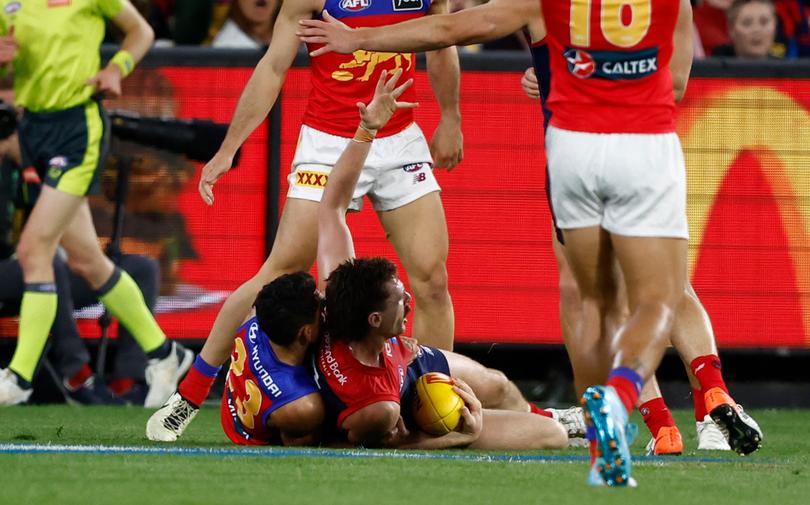 MELBOURNE, AUSTRALIA - APRIL 11: Jake Lever of the Demons is tackled by Charlie Cameron of the Lions during the 2024 AFL Round 05 match between the Melbourne Demons and the Brisbane Lions at the Melbourne Cricket Ground on April 11, 2024 in Melbourne, Australia. (Photo by Michael Willson/AFL Photos via Getty Images)