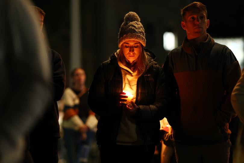 Members of the Ballarat community participate in a rally against men's violence following the alleged murder of three women in the regional Victorian city within the past three months, at Ballarat Train Station in Ballarat, Friday, April 12, 2024. 