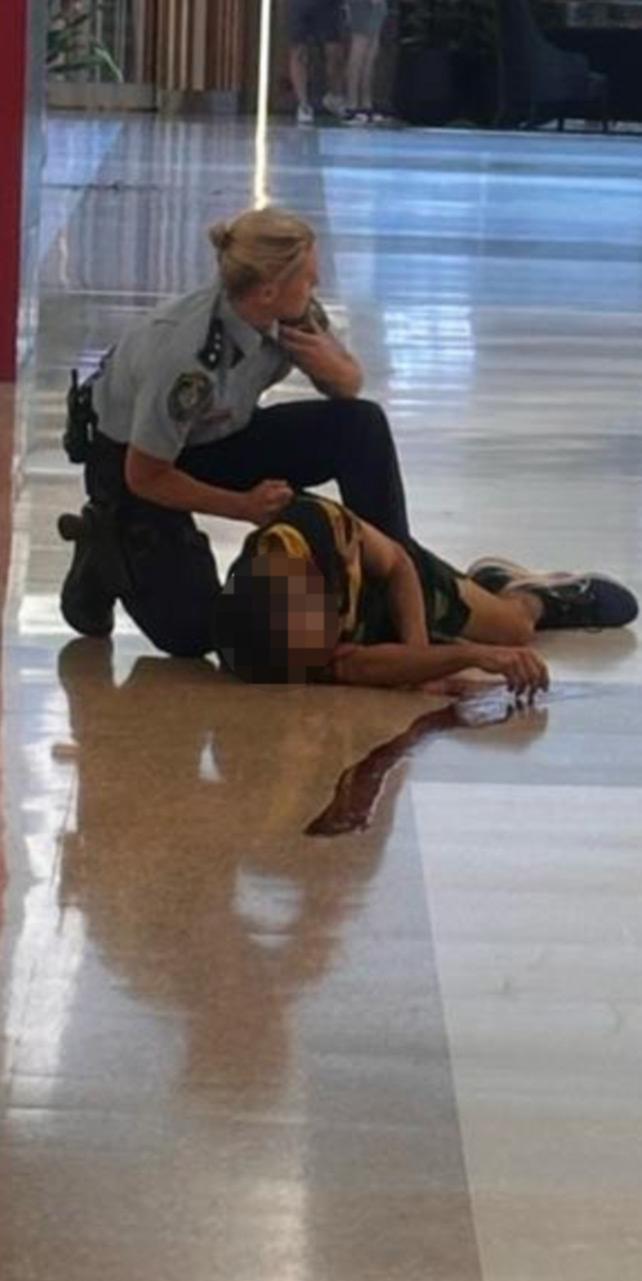 A police officer with an injured man.