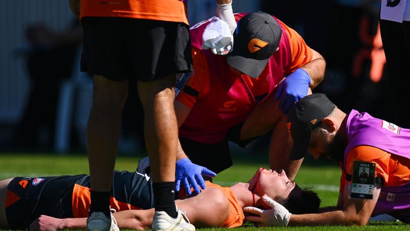 Sam Taylor being treated after he was knocked out.