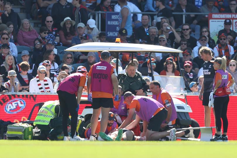CANBERRA, AUSTRALIA - APRIL 13: Sam Taylor of the Giants is treated by medical staff before leaving the field during the round five AFL match between Greater Western Sydney Giants and St Kilda Saints at Manuka Oval, on April 13, 2024, in Canberra, Australia. (Photo by Mark Metcalfe/AFL Photos/Getty Images)