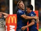 Bryce Cartwright (left) congratulates Daejarn Asi on his match-clinching try for the Eels. (James Gourley/AAP PHOTOS)