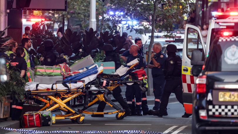 Paramedics push stretchers into the Westfield Bondi Junction shopping centre to retrieve the injured after the stabbing incident in Sydney.