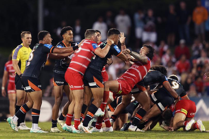SYDNEY, AUSTRALIA - APRIL 14: Players scuffle after a high tackle on Zac Lomax of the Dragons by David Klemmer of the Tigers during the round six NRL match between Wests Tigers and St George Illawarra Dragons at Campbelltown Stadium, on April 14, 2024, in Sydney, Australia. (Photo by Matt King/Getty Images)