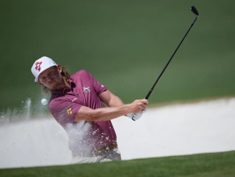 Cameron Smith splashes out of the bunker for a spectacular eagle on the second hole at Augusta. (AP PHOTO)