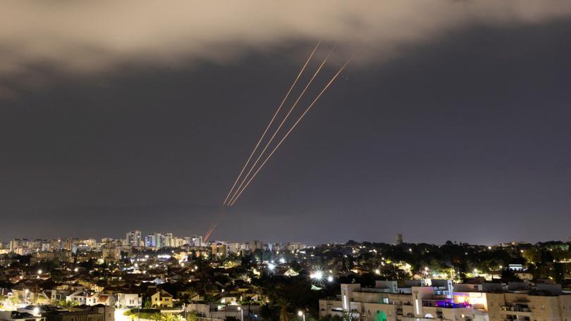 An anti-missile system operates after Iran launched drones and missiles towards Israel.