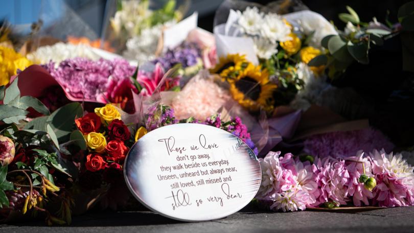 Some of the flowers left at makeshift memorial outside the Westfield Bondi Junction shopping centre . 