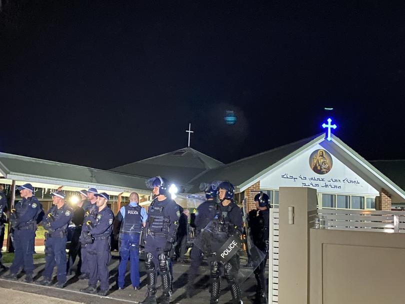 At about 11.32pm, the car park at Christ the Good Shepherd is packed with police officers, some wearing riot gear.