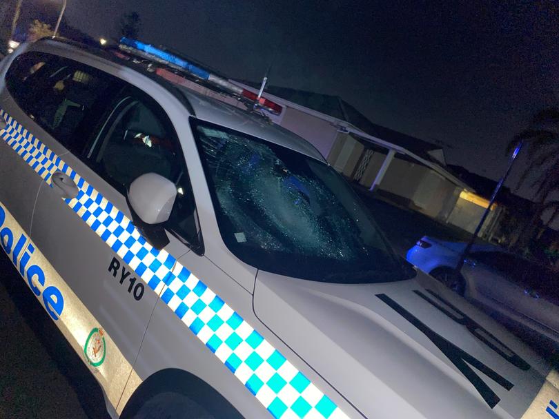 A police car parallel to the church had a smashed driver window and mirror as well as a shattered windscreen.