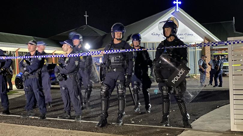 A witness has recounted the terrifying moment a church was swarmed by rioters after a Bishop was allegedly stabbed during a Monday night mass.