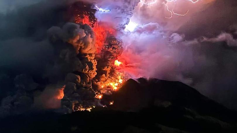 Mount Ruang spews hot lava and smoke into the air.