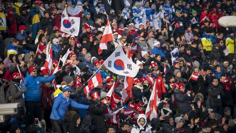 Fans watch a cross-country ski race at the 2018 Winter Olympics in Pyeongchang, South Korea, Feb. 10, 2018. 