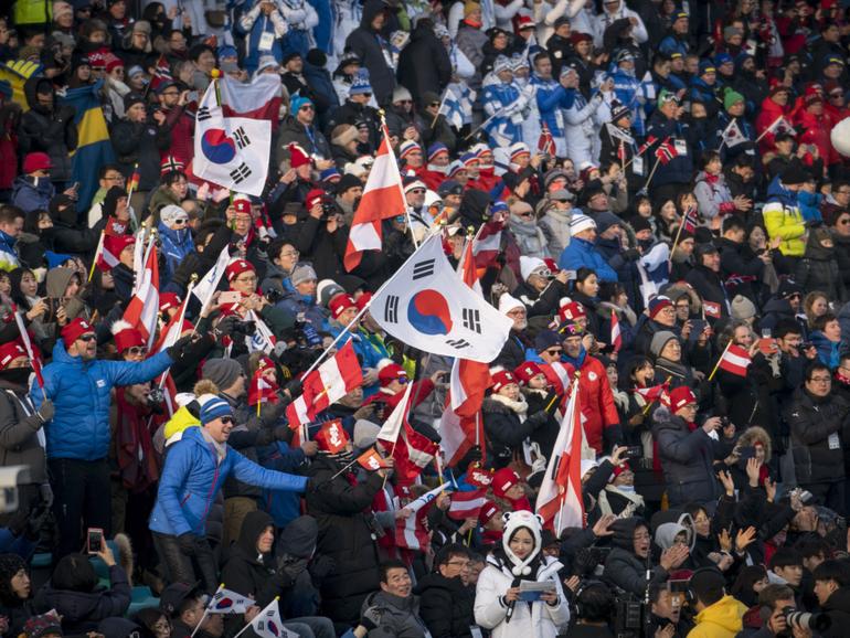 Fans watch a cross-country ski race at the 2018 Winter Olympics in Pyeongchang, South Korea, Feb. 10, 2018. 