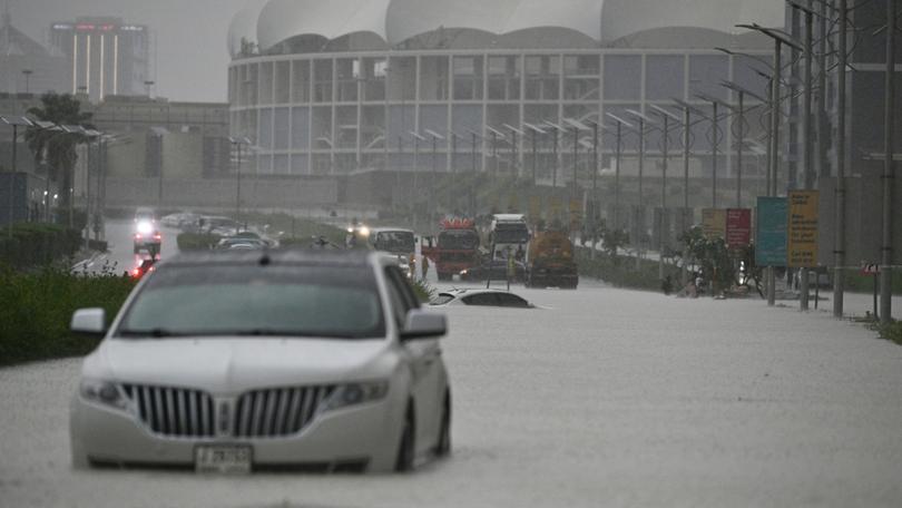 DUBAI, UNITED ARAB EMIRATES - APRIL 16: Vehicles hardly move on flooded streets due to heavy rain in Dubai, United Arab Emirates on April 16, 2024. The torrential rain in Dubai, United Arab Emirates (UAE), had a detrimental effect on daily life. Flooding ensued as a result of the downpour, leading to several vehicles being submerged on the streets and avenues. (Photo by Stringer/Anadolu via Getty Images)