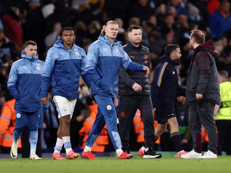 Erling Haaland and Manuel Akanji of Manchester City look dejected after the team's defeat.
