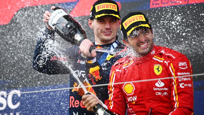 Max Verstappen celebrates his Japan Grand Prix win with third placed Carlos Sainz earlier this month.