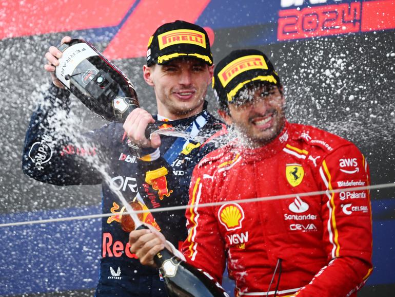 Max Verstappen celebrates his Japan Grand Prix win with  third placed Carlos Sainz earlier this month.