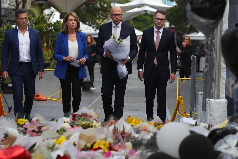 Richard Shields, Kellie Sloan, Australian Opposition Leader Peter Dutton and Senator Andrew Bragg lay flower tributes at the edge of Westfield Bondi Junction during a day of reflection on April 18, 2024 in Bondi Junction, Australia.