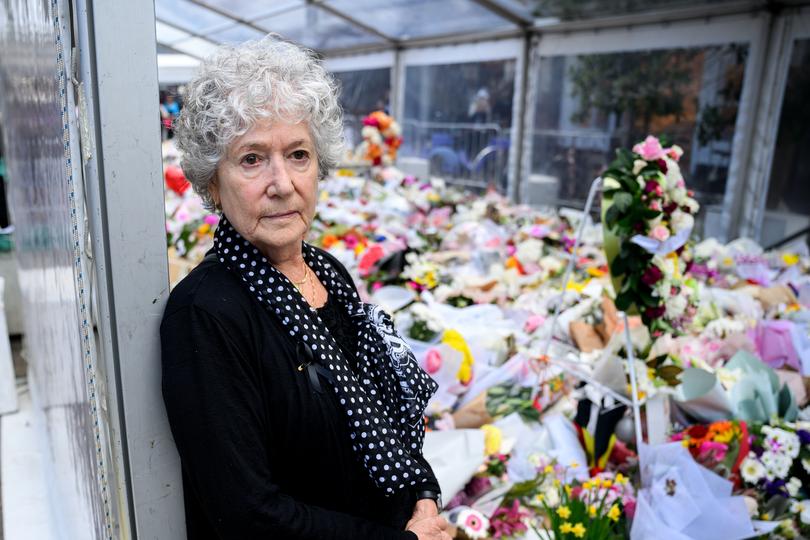 Hazel Stein poses for a photograph whilst visiting the floral tributes at Bondi Junction following a tragic knife attack in Sydney, Thursday, April 18, 2024. 