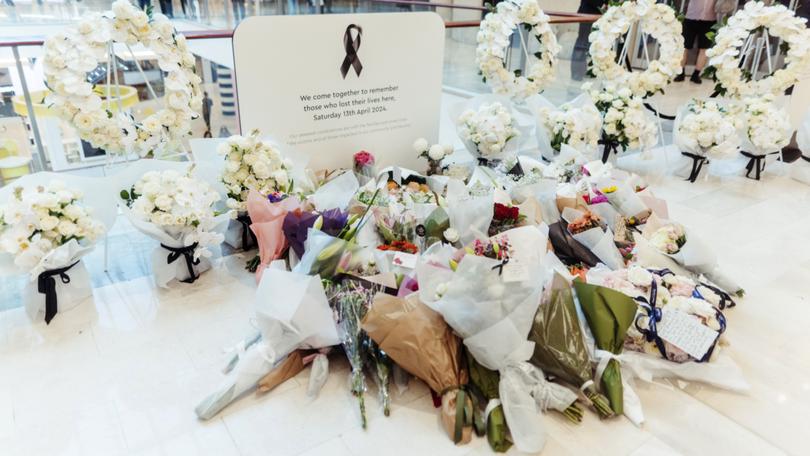Flower bouquets are seen at a memorial set up inside the Westfield Bondi Junction shopping centre as part of the community’s reflection day.