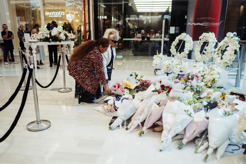 People lay down flowers at a memorial set up inside the Westfield Bondi Junction shopping centre as part of the community’s reflection day in Bondi, Sydney, Thursday, April 18, 2024. 