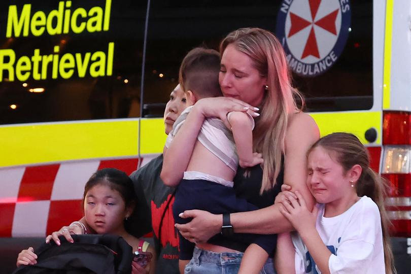 A family leaves the Westfield Bondi Junction shopping mall after a stabbing incident in Sydney on April 13, 2024. - Australian police on April 13 said they had received reports that "multiple people" were stabbed at a busy shopping centre in Sydney. (Photo by David GRAY / AFP) DAVID GRAY