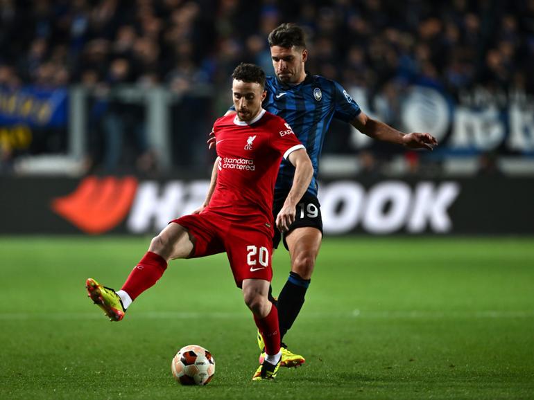 Diogo Jota of Liverpool is challenged by Berat Djimsiti of Atalanta.