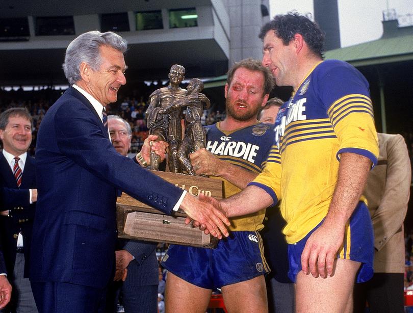 Australian Prime Minister Bob Hawke (L) congratulates Michael Cronin (R) and Ray Price (C) of the Eels after winning the 1986 NSWRL Grand Final between the Parramatta Eels and the Canterbury Bulldogs held at the SCG. Parramatta won 4-2.