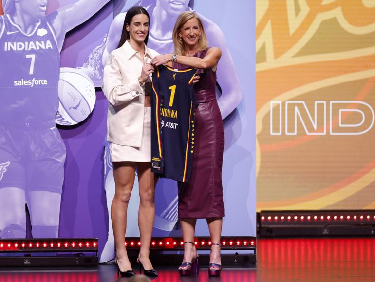 Caitlin Clark poses with WNBA Commissioner Cathy Engelbert after being selected first overall pick by the Indiana Fever.