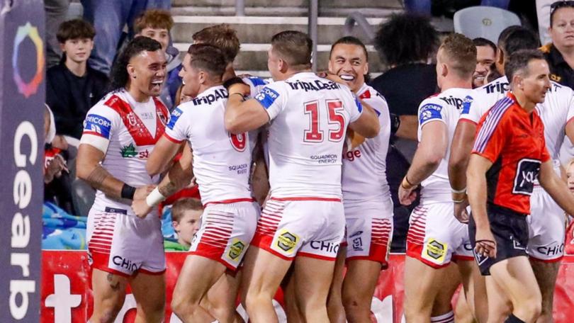 Dragons players celebrate after a try.